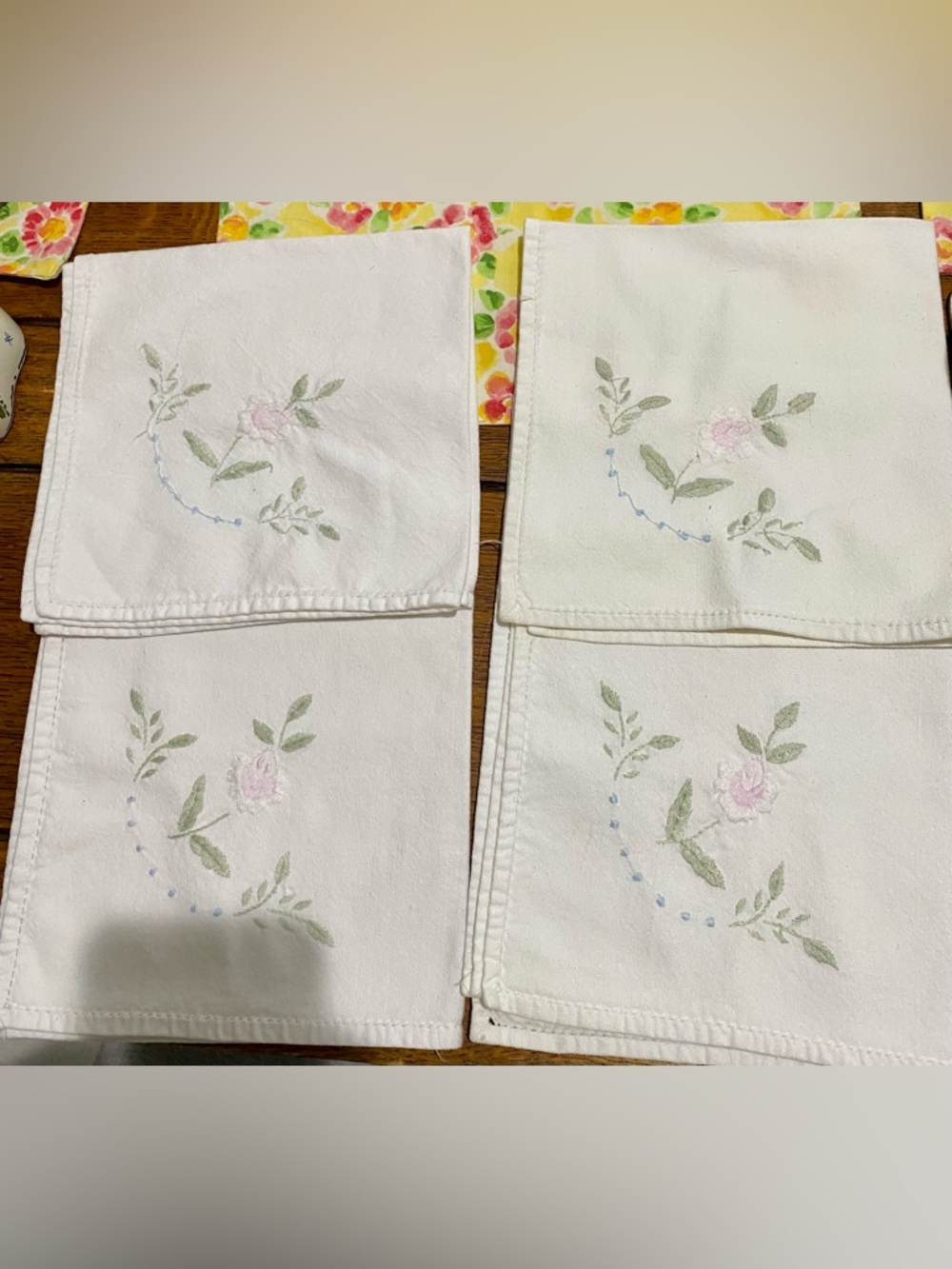 Four Cotton embroidered napkins. White with purple, blue and green florals. GUC